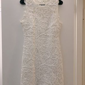 A large white sans souci dress